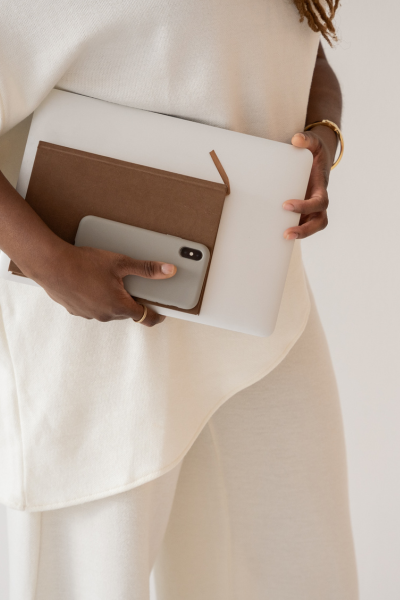 Woman holding notebook and phone ready for 1:1 coaching session