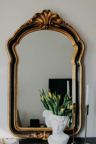 Ornate mirror reflecting a bright interior, symbolising self-reflection in mindfulness, therapy and coaching