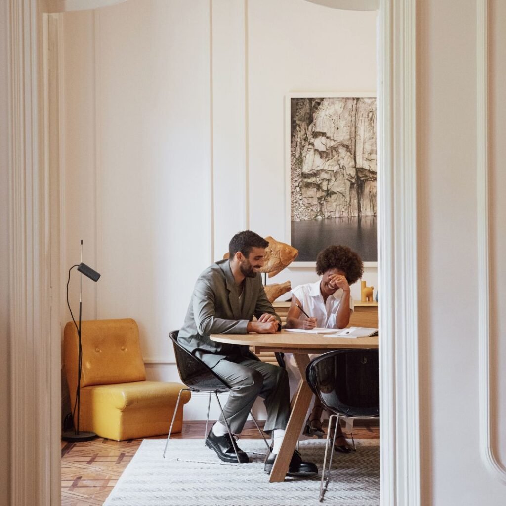 Coaching conversation between two people at a workspace
