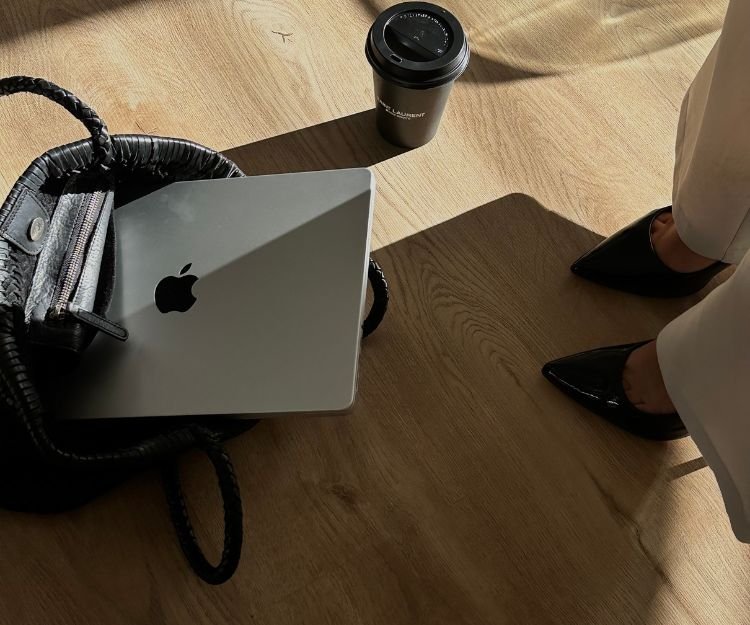Laptop, work bag and coffee on the floor