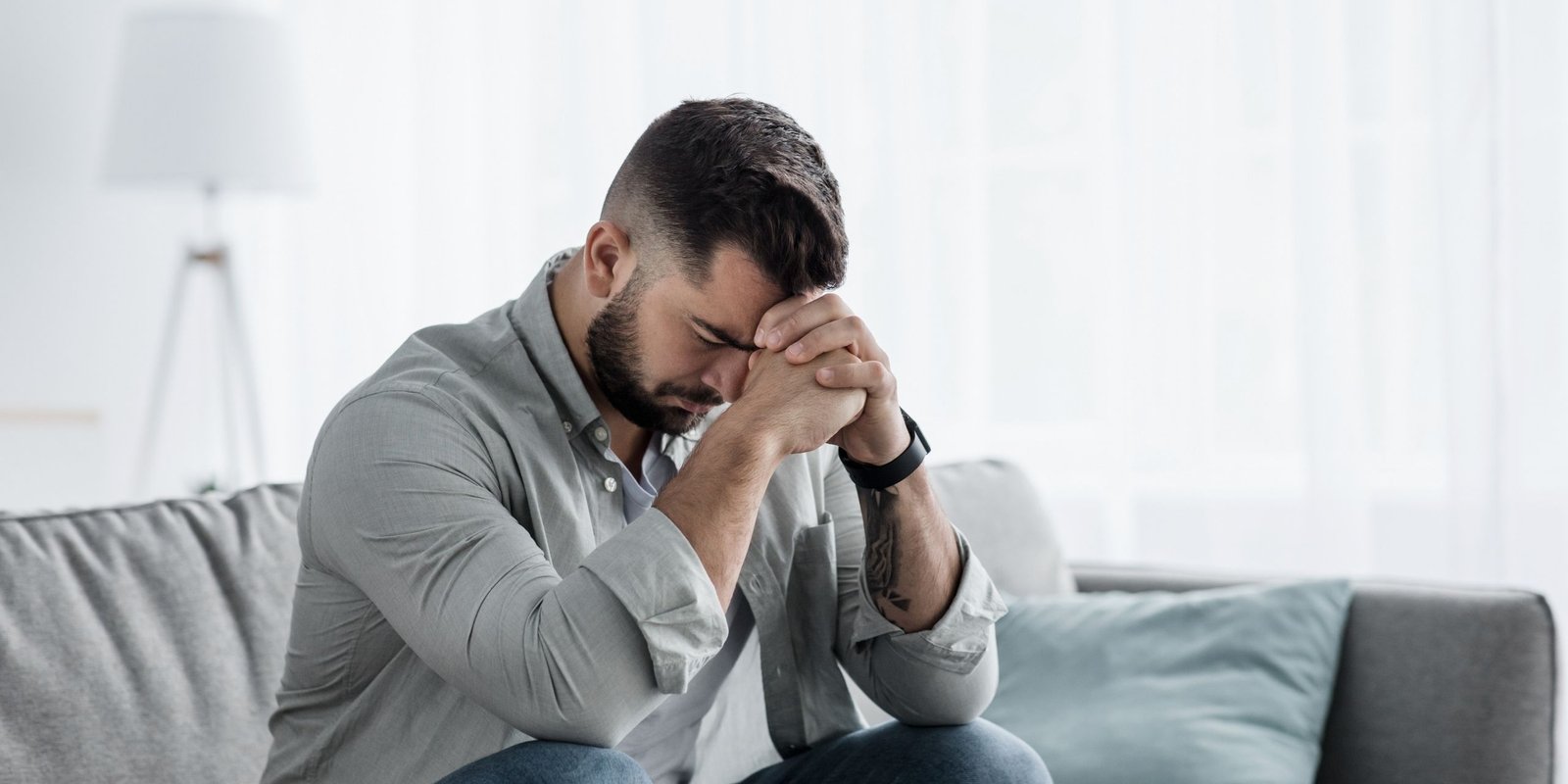 Anxious entrepreneur sitting on sofa