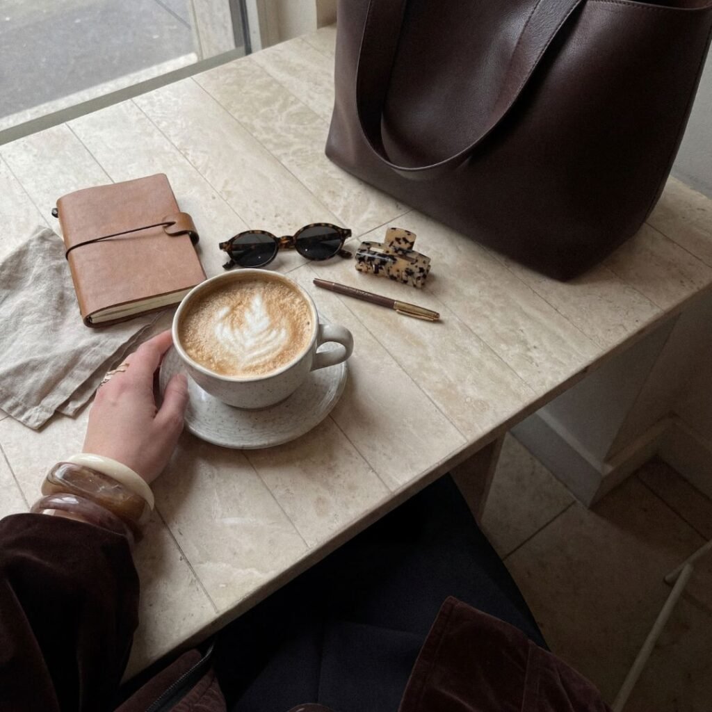 at a cafe, reflecting on stress and rest