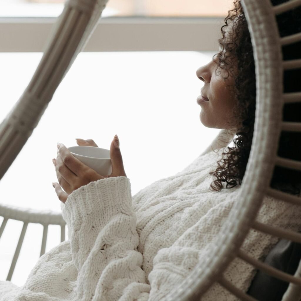 erson sitting in a light-filled room by a window, representing the psychological approach to chronic pain management and building a different relationship with it