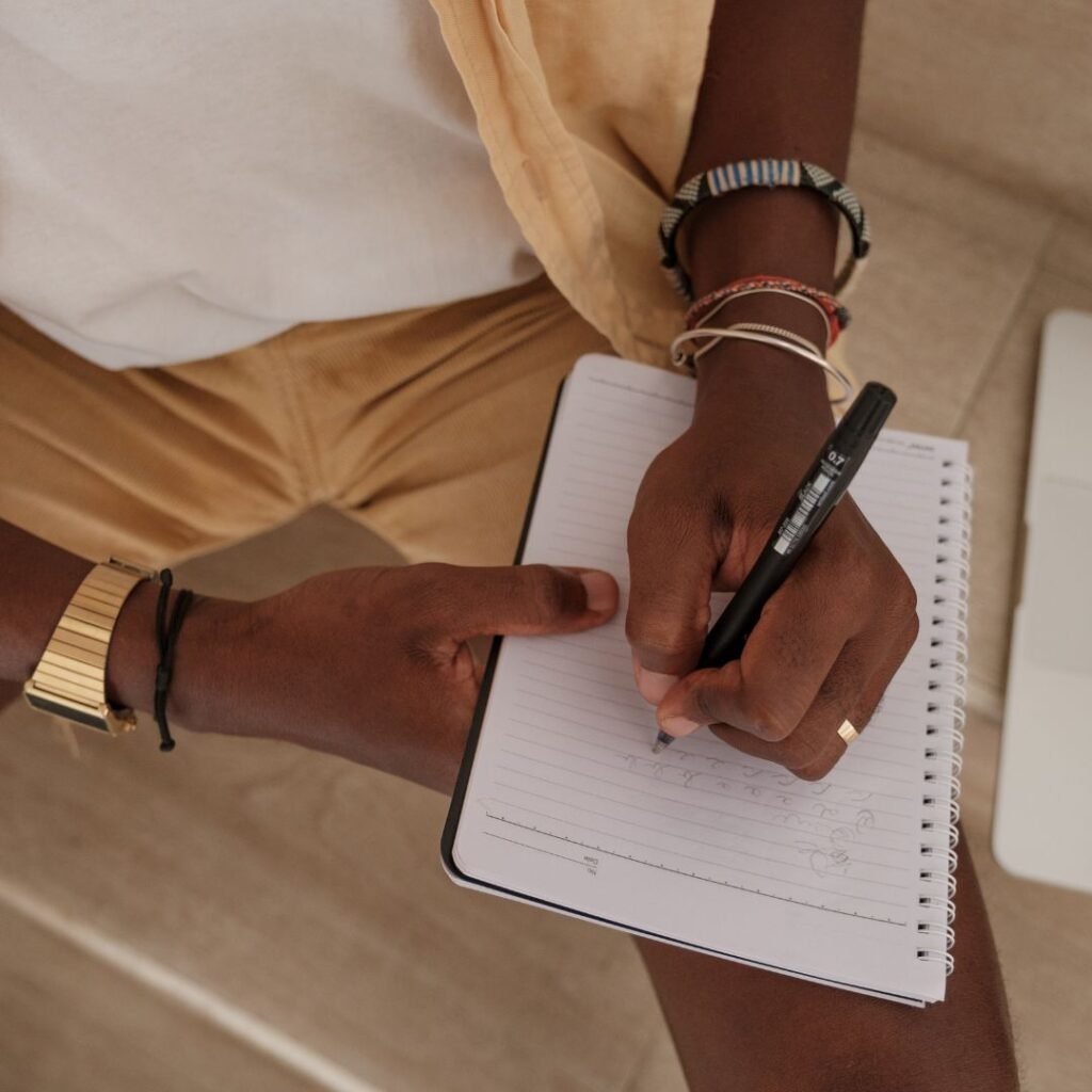 Woman writing notes at a desk, representing a personalised treatment plan for stress therapy