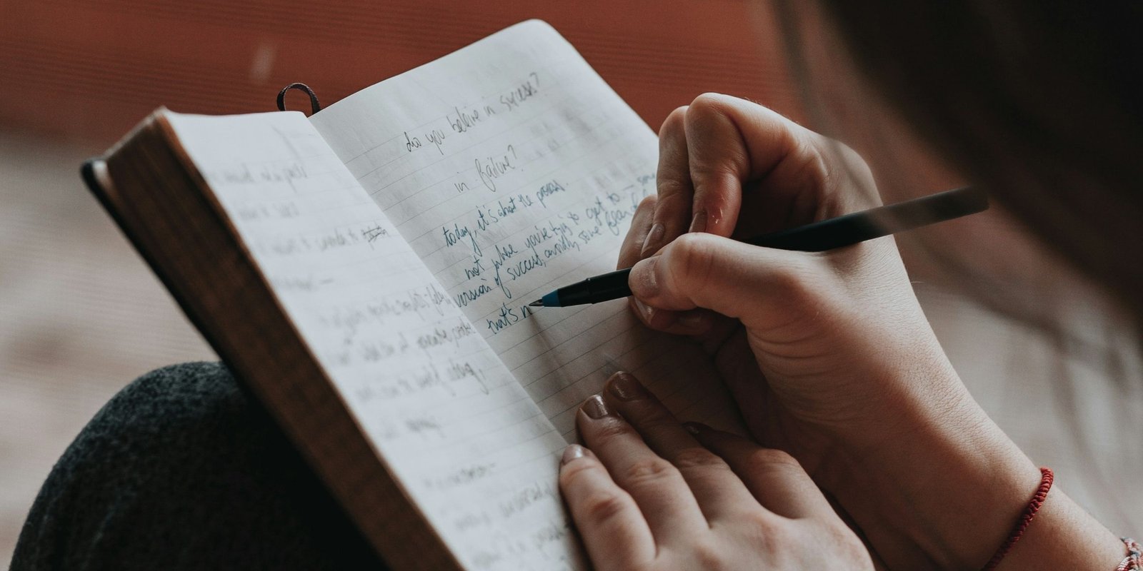 Woman journalling at desk for live group coaching session