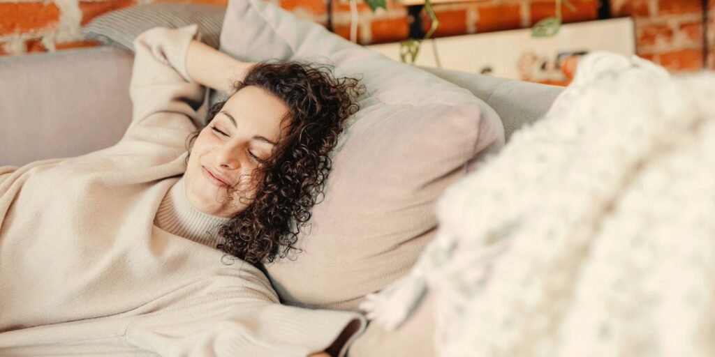 Woman resting peacefully representing guided audio and mindfulness practices