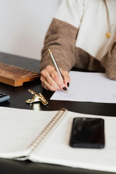 Lucy Mundy working at her desk, entrepreneur coaching available online and in Warwickshire at Your Mind Works