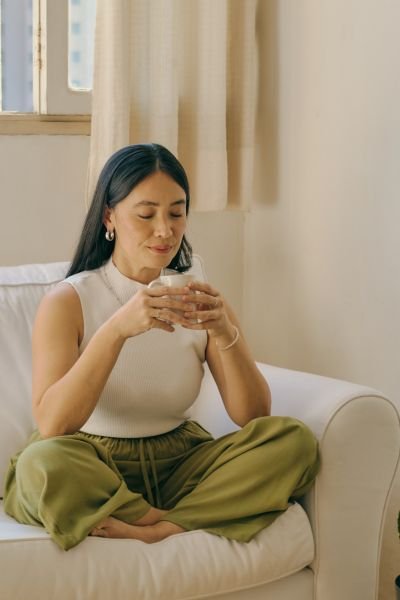 Woman practising mindfulness, seated calmly at home