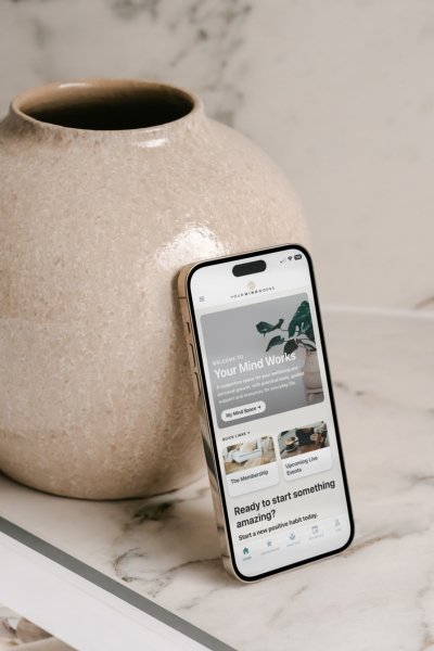 Your Mind Works personal development membership app displayed on an iPhone