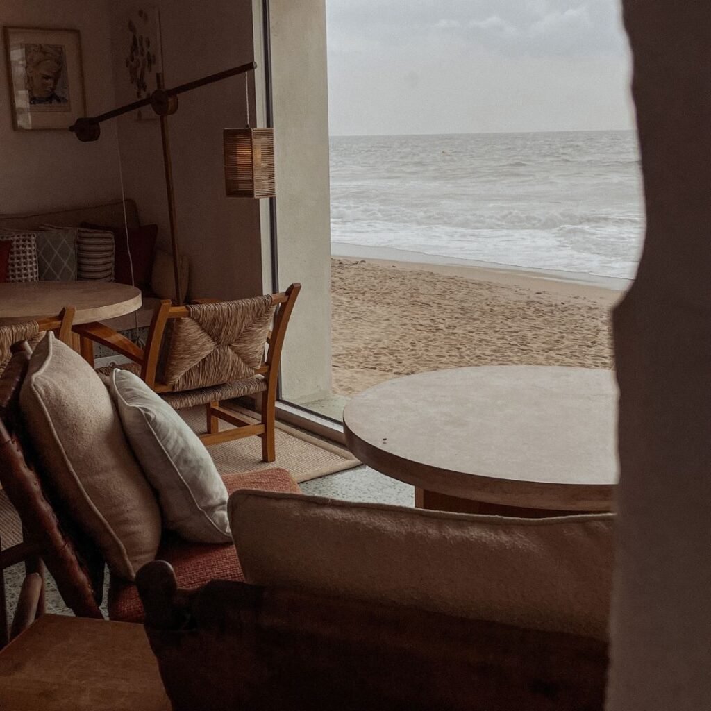 Peaceful view of a quiet beach from a cosy seaside room.